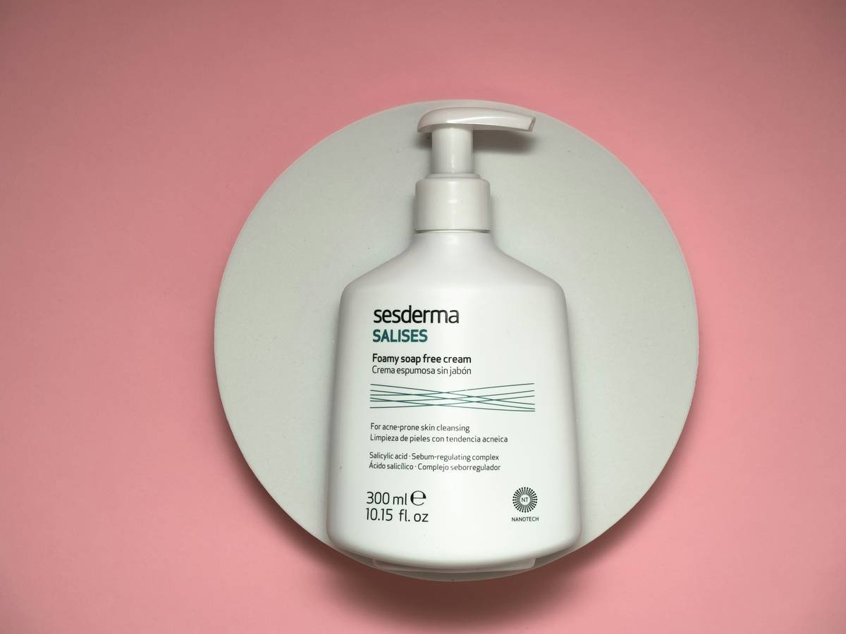 close-up of organic oil based cleanser bottle with cold-pressed jojoba and sunflower oils