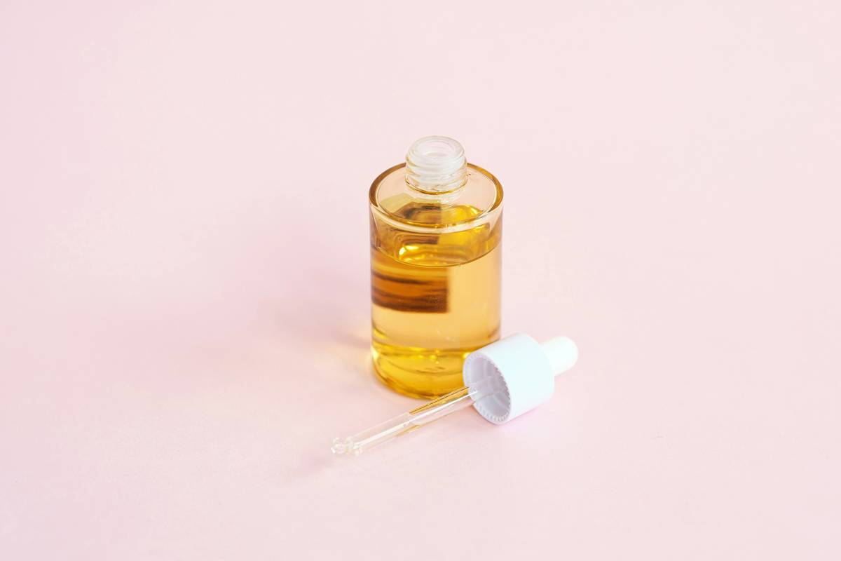 Close-up of natural organic facial cleanser bottle with botanical ingredients visible
